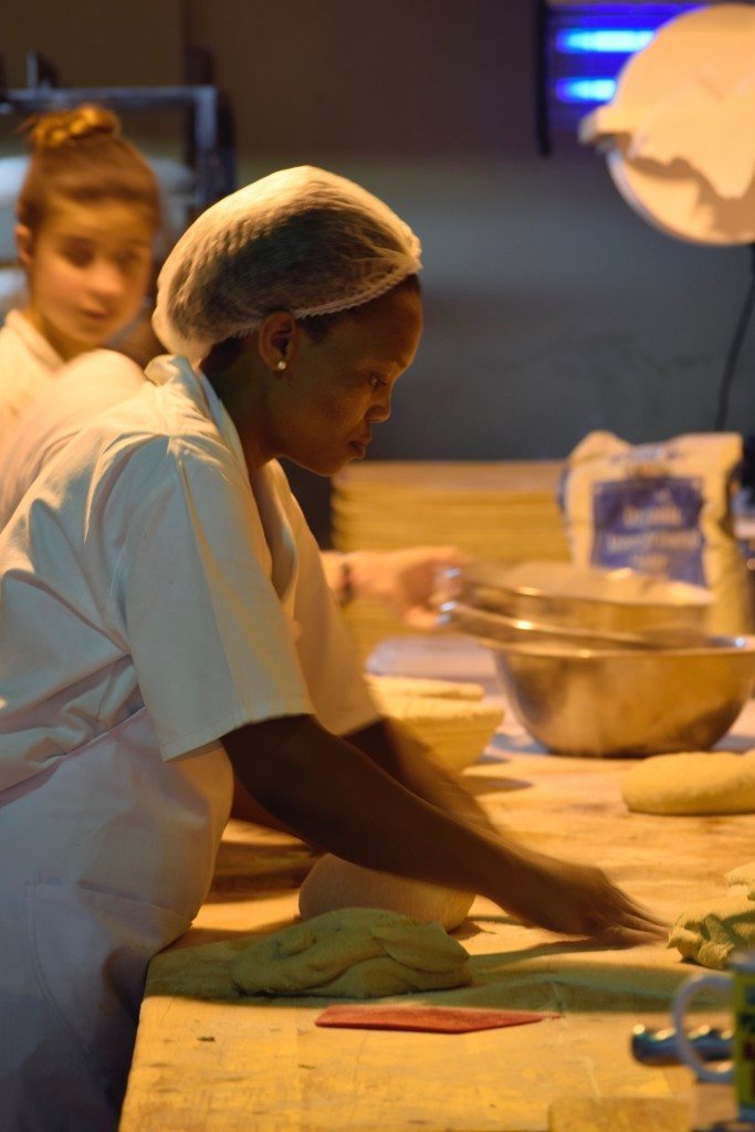 A woman kneading bread in a Stellenbosch bakery-Stellenbosch wine tours are fun after exploring downtown.