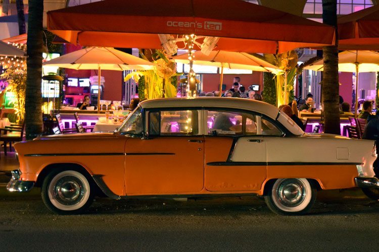 A classic car parked on Ocean Drive in South Beach Miami, one of the best places to visit