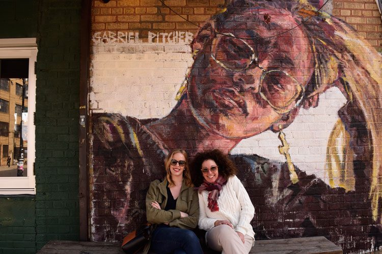 Mother and daughter posing in front of a mural in Bushwick, Brooklyn.