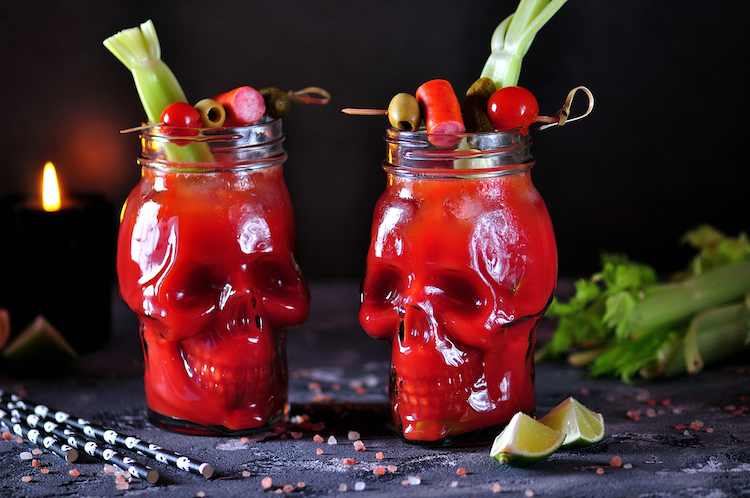 Two Bloody Mary Halloween cocktails in skull glasses.