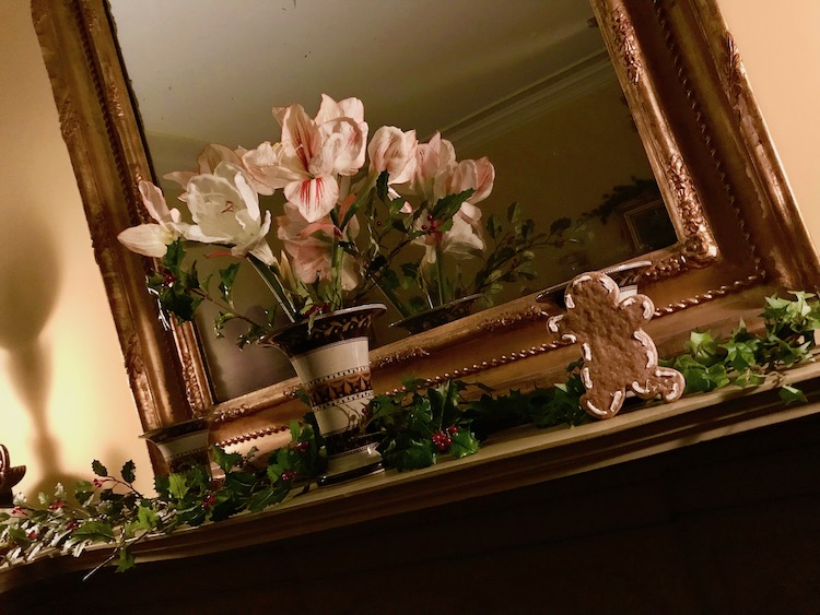 greens, flowers and a gingerbread man on a mantel at Boscobel during holiday twilight tours