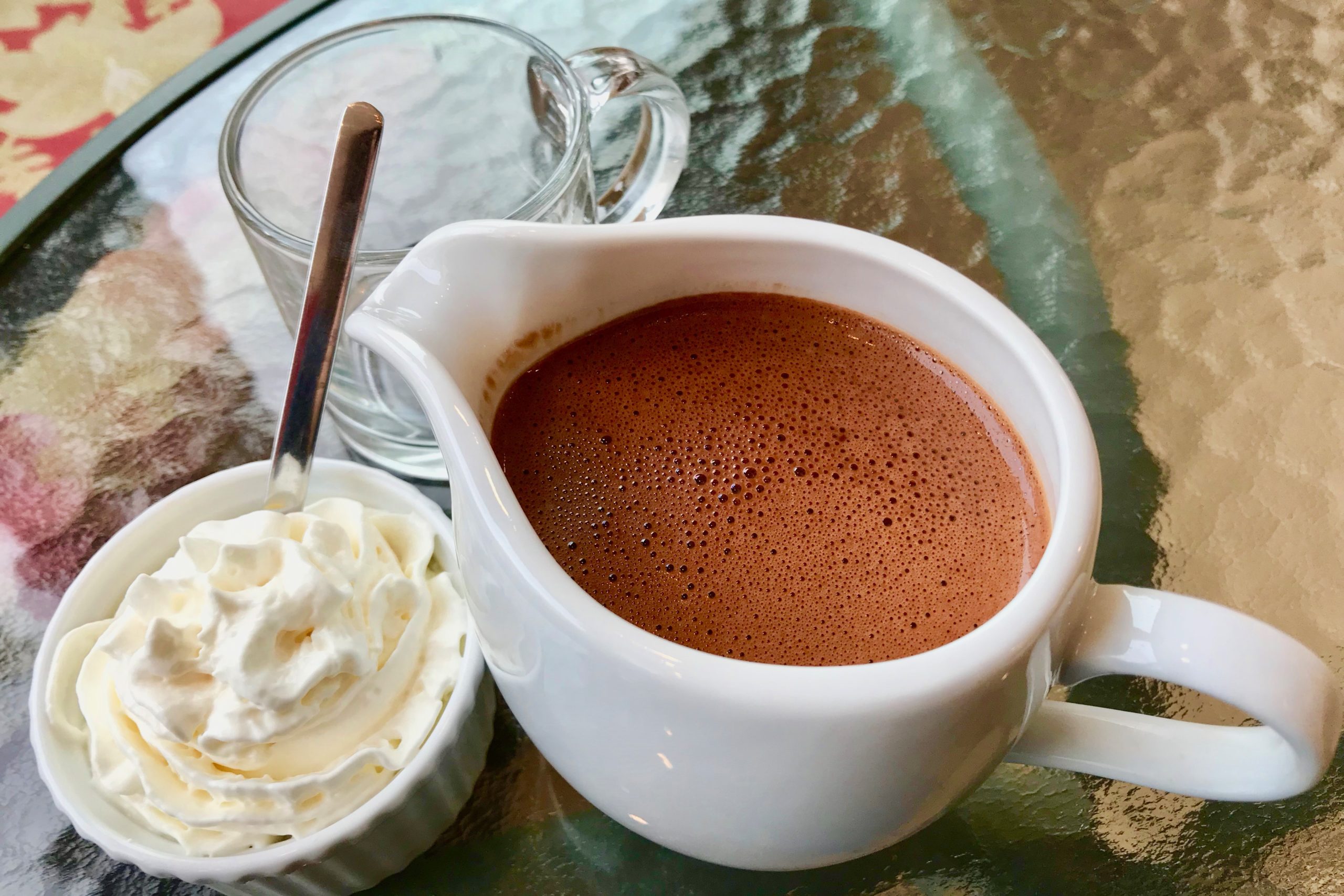 pitcher of hot chocolate and whipped cream at verdigris in the hudson valley ny