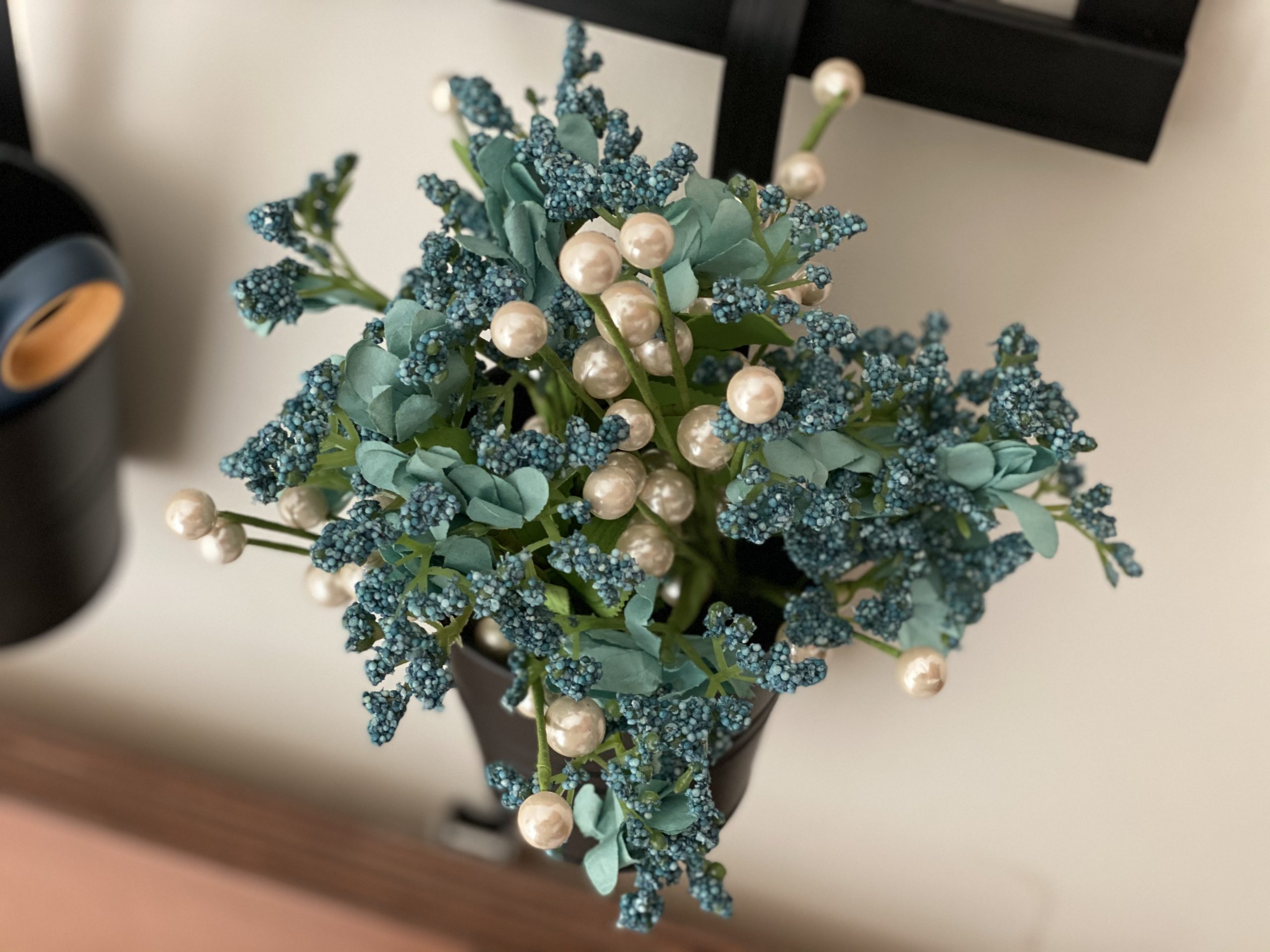 Blue and pearl blooms fake flowers hanging from a 1Thrive command center