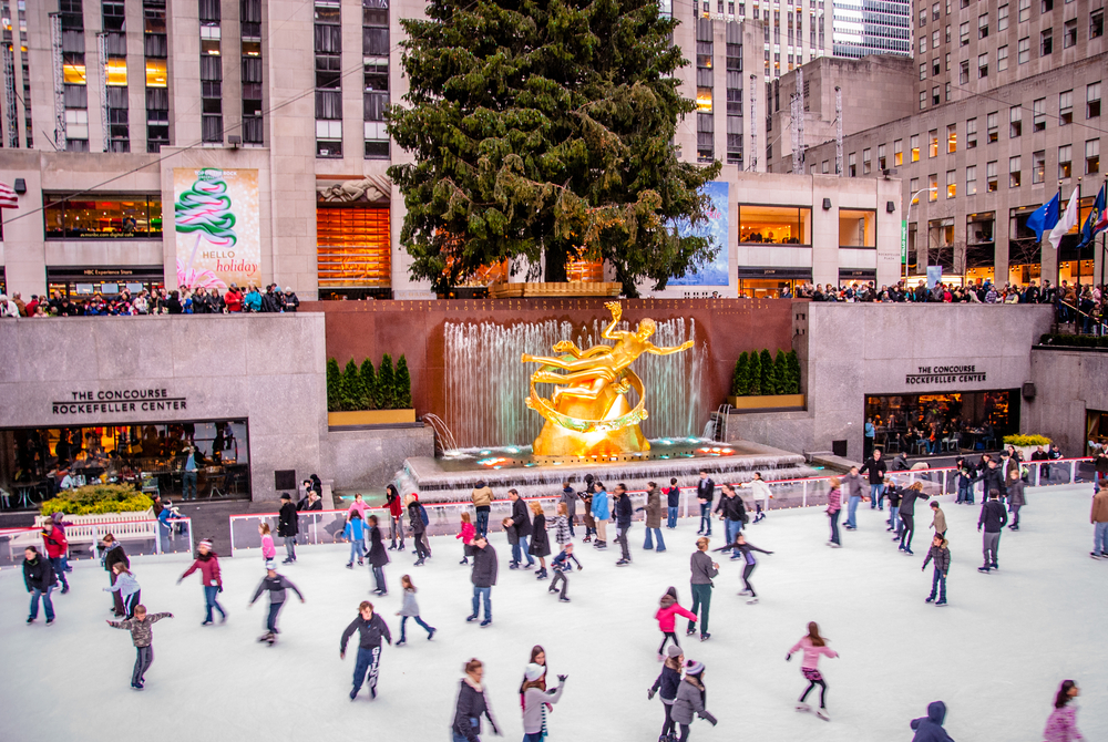 Skaters on the ice rink in front of the Prometheus statue in Rockefeller Center NYC